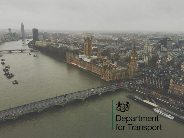 High view over the River Thames showing the Houses of Parliament and other London landmarks. The Department of Transport logo is on the bottom right hand corner.