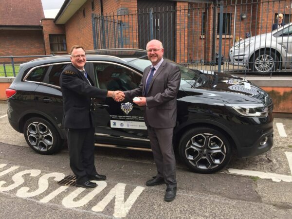 Image of port chaplain being presented with a new car to be used for ship and home visits, as well as transporting seafarers in and around the ports.